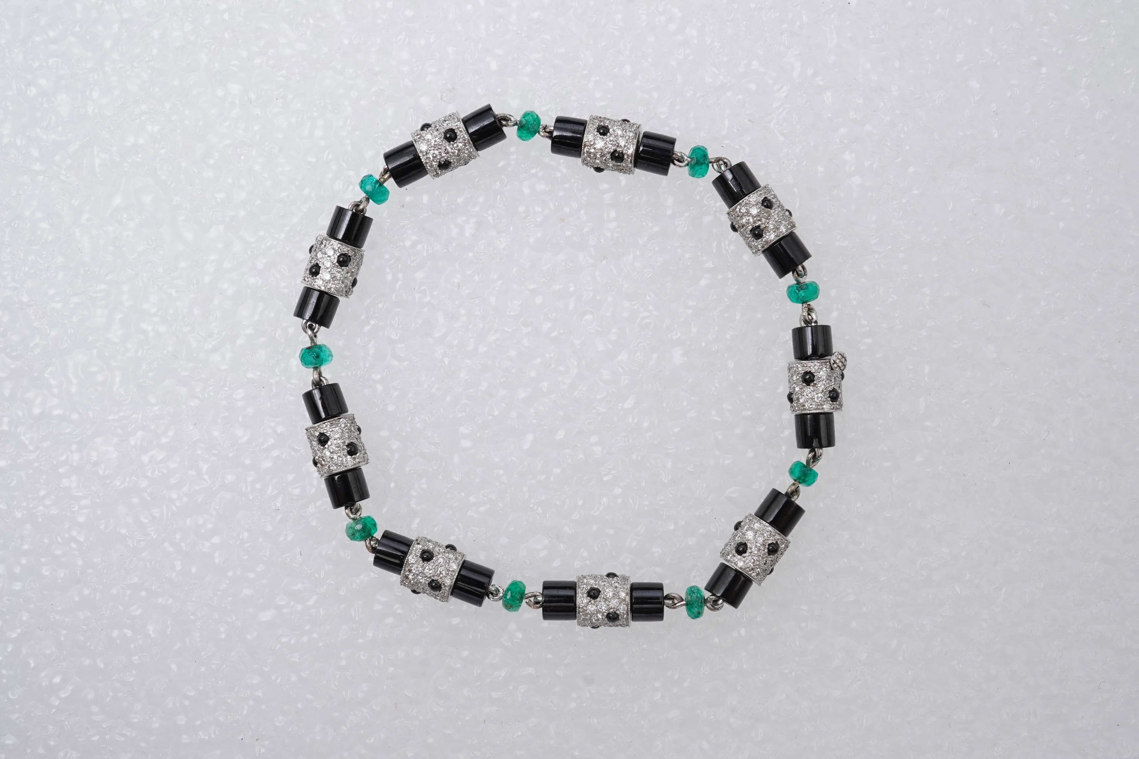 A stylish onyx, emerald and diamond bracelet